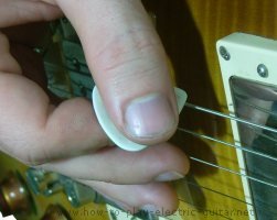 Image of a guitar pick held at an angle